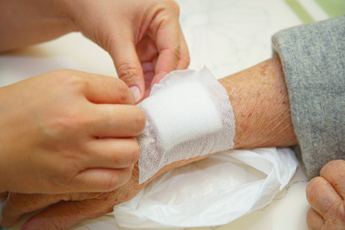 Caring for wound on elderly person with bandage